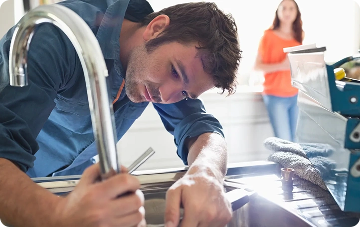 Licensed plumber repairing a water heater in a Santa Clara, CA home